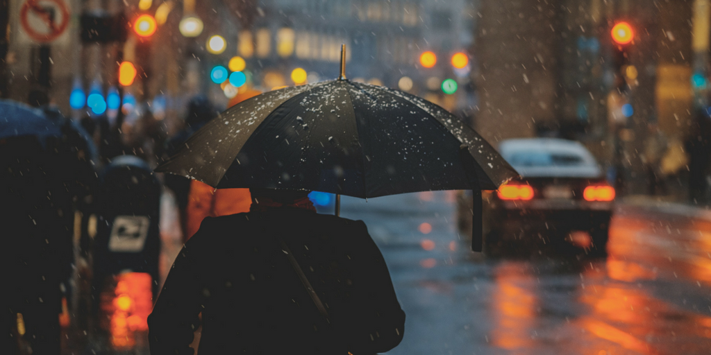 standing under umbrella